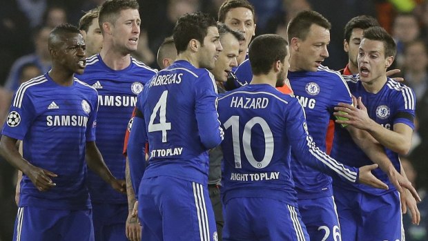 Spot the ref: Nine Chelsea players surround referee Bjorn Kuipers demanding he show a red card to Zlatan Ibrahimovic.