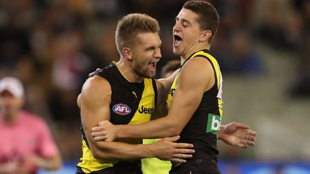 Tigers Dan Butler (left) and Jason Castagna celebrate after scoring a goal.