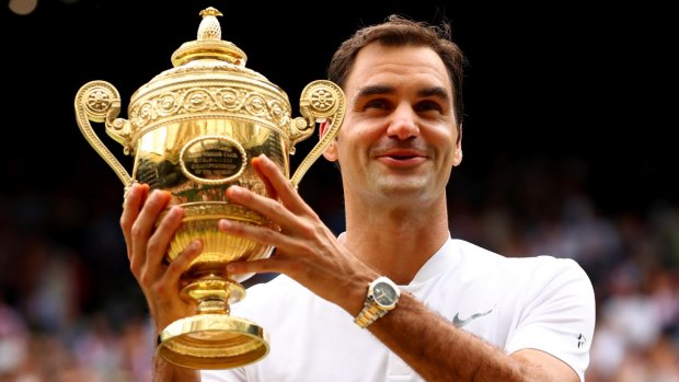 Roger Federer enjoys the spoils after winning his eighth Wimbledon title.