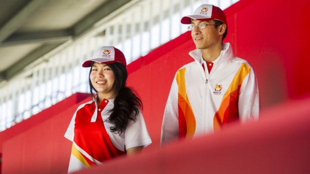 Tatsanee Benjaananpong, 25, and Chen Tang, 24, show off their volunteer uniforms for next year's Asian Cup at Canberra Stadium. 