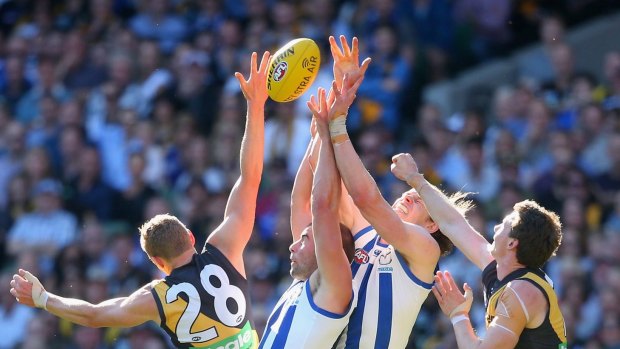 MELBOURNE, AUSTRALIA - SEPTEMBER 13:  Ben Cunnington and Ben Brown of the Kangaroos compete for a mark against Taylor Hunt and Dylan Grimes of the Tigers during the First AFL Elimination Final match between the Richmond Tigers and the North Melbourne Kangaroos at Melbourne Cricket Ground on September 13, 2015 in Melbourne, Australia.  (Photo by Quinn Rooney/Getty Images)