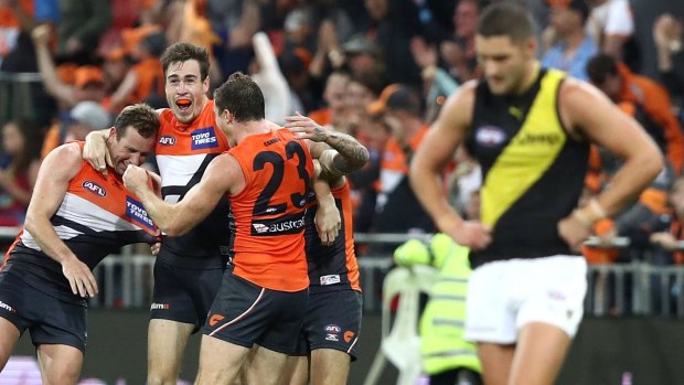 Out of jail: Jeremy Cameron and teammates celebrate the GWS Giants' comeback win last month.