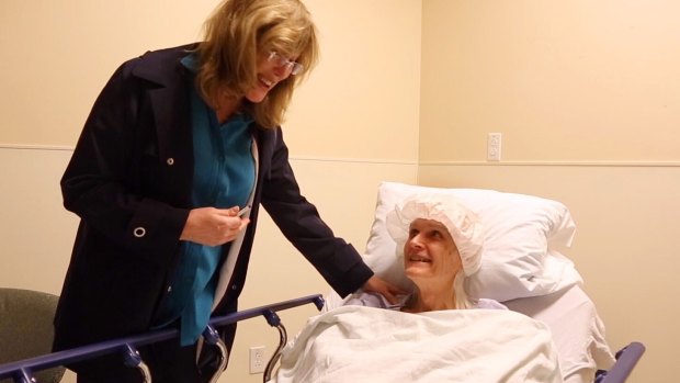 Kate (formerly Bill) Rohr talks with her doctor Marci Bowers (left) after surgery.
