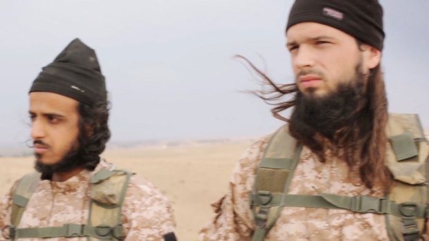 French recruits: A screen grab from the execution video. The man on the right is believed to be French citizen Maxime Hauchard. The other man  has been identified as Mickael Dos Santos.