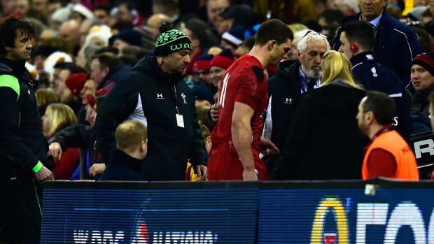 Wales winger George North  leaves the field for treatment in the first half against England.