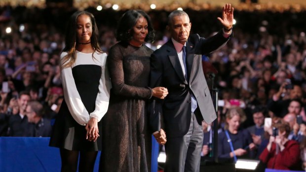 President Barack Obama waves as he is joined by First Lady Michelle Obama and daughter Malia Obama after giving his presidential farewell address.