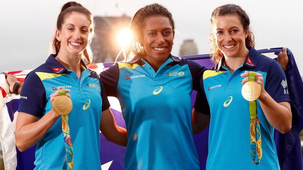 Alicia Quirk, Ellia Green and Emilee Cherry pose with their Olympic gold medals after the Australian women's sevens team were awarded Order of Australia Medals.