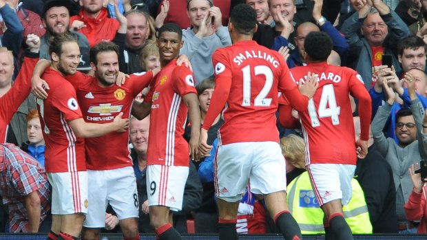 Manchester United's Juan Mata celebrates with team mates after scoring.