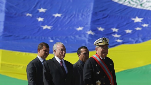 Brazilian President Michel Temer, second left, and the Commander of the Navy Admiral Eduardo Bacellar Leal Ferreira, right, arrive at a ceremony in Brasilia on Friday.