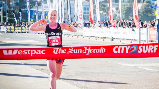 Cassie Fien, the first woman to cross the finish line at the the Sun Herald City2Surf at Bondi Beach.
