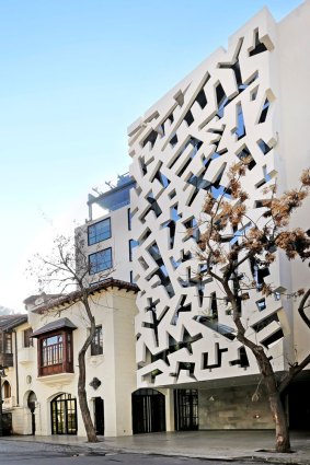 The hotel's facade features a geometric, distinctive design.