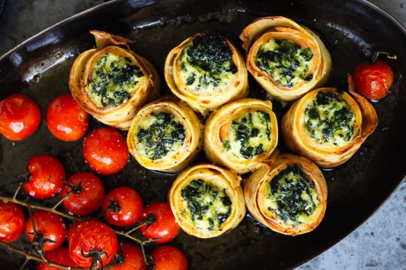 Smoked salmon crepe rolls with roast tomatoes and horseradish cream.