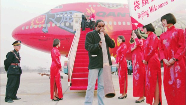 Allan Dargin performs on the tarmac in front of the Boeing 747 known as Wunala Dreaming, after the inaugural flight of Qantas' new service to Beijing in 1995.