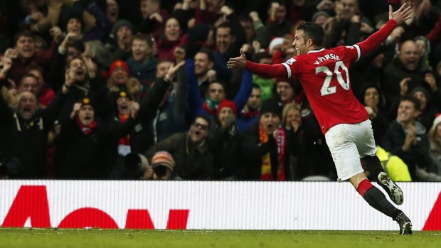 Manchester United's Robin van Persie celebrates after hitting the target against Liverpool at Old Trafford on Sunday. 