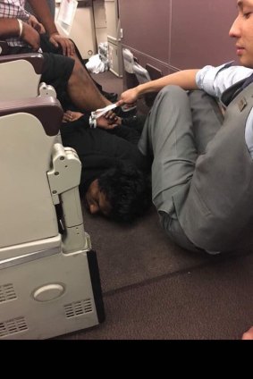 A picture tweeted by one of the passengers appears to show the man face-down on the floor after being handcuffed.