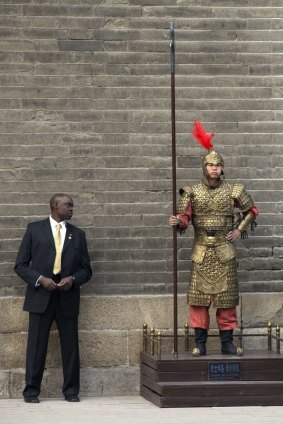 Vigilant: A US Secret Service officer checks a Chinese performer dressed as an ancient warrior as US first lady Michelle Obama visits the 600-year-old Xi'an city wall.
