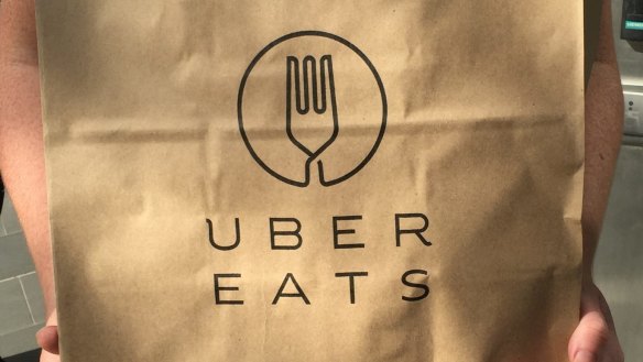 Gemima Cody collects a delivery of UberEats on its first day of service, from Supernormal.