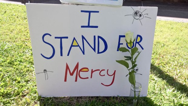 A sign calling for mercy at the Brisbane candlelight vigil.