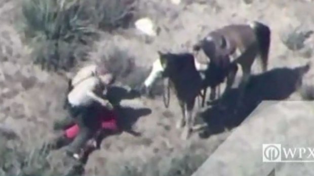 A still from a video taken from a helicopter of Francis Pusok being beaten by deputies after a horseback pursuit.