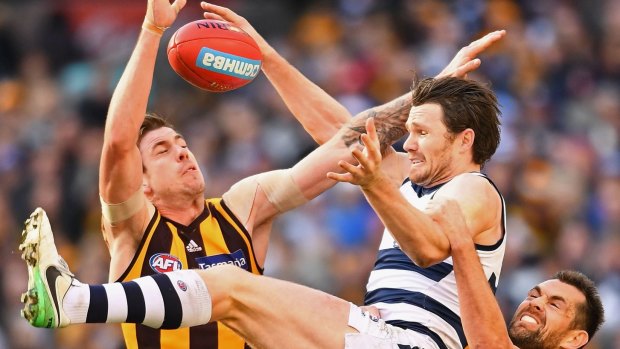 Patrick Dangerfield attempts to mark over the top of Hawthorn's 300-gamer Luke Hodge at the MCG on Saturday afternoon.