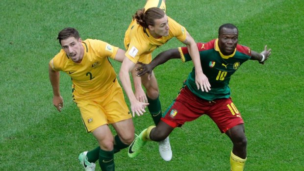 Australia's Jackson Irvine falls between teammate Milos Degenek, left, and Cameroon's Vincent Aboubakar during the Confederations Cup. 