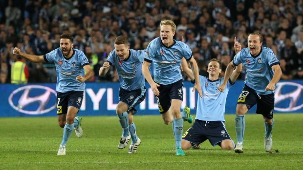 Magic moment: Sydney FC players celebrate after winning the grand final.