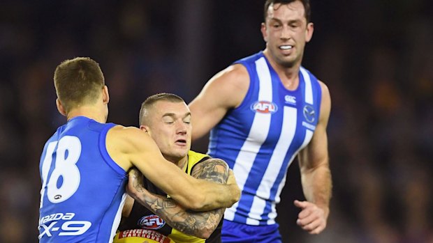 Dustin Martin is tackled by Shaun Atley as Todd Goldstein watches on. The trio could be teammates next year. 