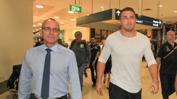 Sam Burgess arrives at Sydney Airport with South Sydney CEO John Lee.
