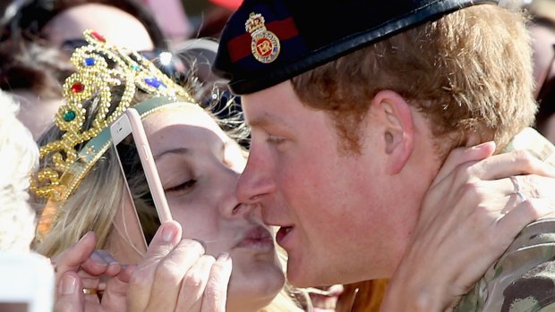When Harry met Vicky: Prince Harry is kissed by royal fan Victoria McRae during a walkabout outside the Sydney Opera House.