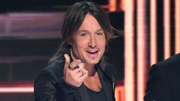 Keith Urban accepts his Single of the Year prize at the 51st CMA Awards in Nashville.