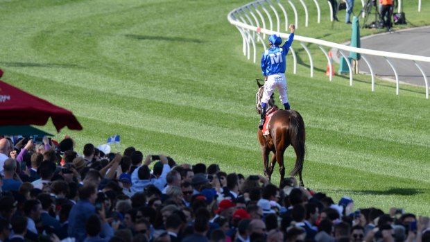 Standing ovation: The crowd erupts as Bowman leads Winx past the grandstand.