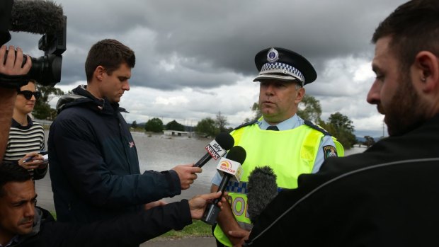 Inspector Brian Tracey, of Maitland police, talks to the media at Cessnock Road.