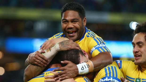 No longer teammates: Chris Sandow congratulates Tim Mannah after the prop scored a try earlier this month.