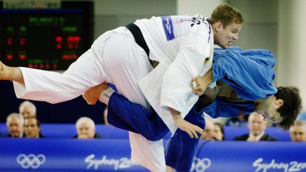 Olympic heritage: Dan Kelly puts his American opponent in a hold during their judo clash in the Sydney 2000 Olympics.