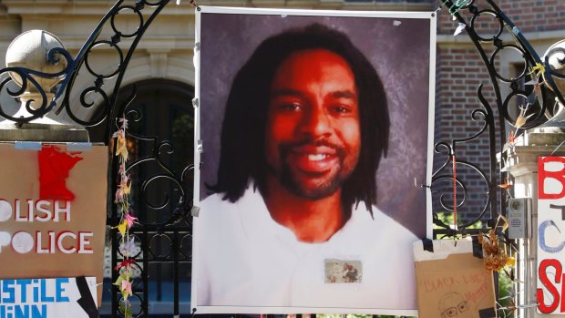 A memorial including a photo of Philando Castile adorns the gate to the governor's residence in St Paul, Minnessota, in July. 