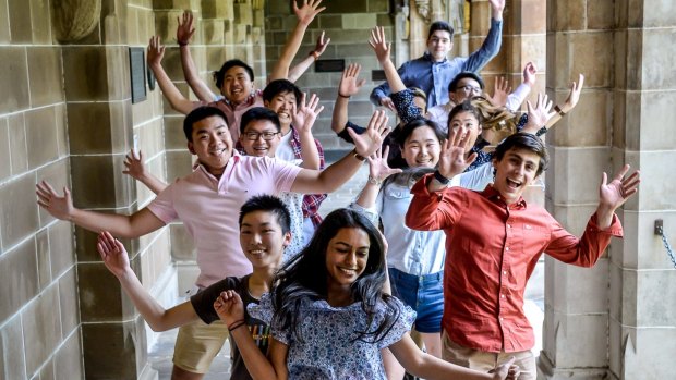 High-achieving exam students celebrate being awarded university scholarships.  