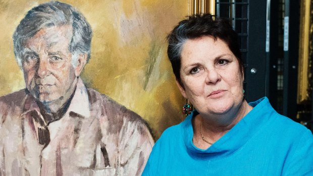 Daughter Melanie Bryan with the Judy Cassab portrait of her father, Morris West.
