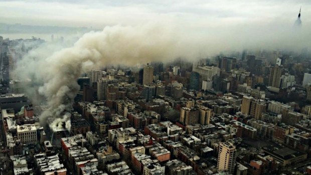 Smoke billows across Manhattan towards the Empire State Building from the East Village fire.