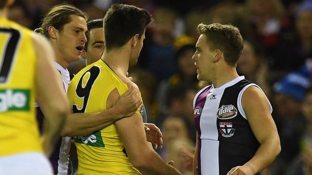 Trent Cotchin of the Tigers (second from right) and Jack Lonie of the Saints are seen moments are wrestling after the punch.