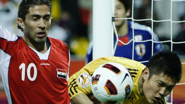'12 million will want to kill me': Firas al-Khatib, left, plays for Syria against Japan in the AFC Asian Cup in 2011.