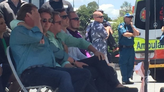 Cole Miller's brother Mitch, seated beside their other brother Billy, puts his arm around dad Steve.