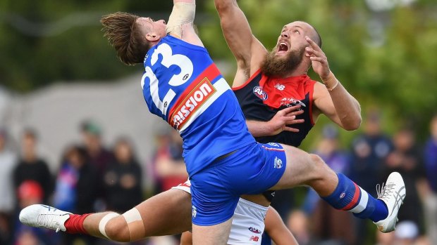 Jordan Roughead and Max Gawn in action. Roughead later hurt his knee.