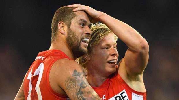 Lance Franklin of the Swans is congratulated by Isacc Heeney after kicking a goal.