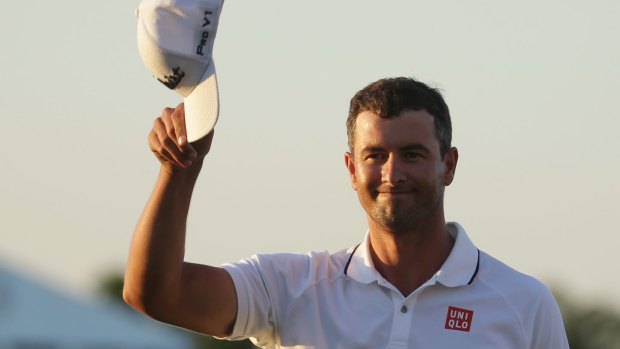 Adam Scott tips his cap after winning the World Golf Championships in Miami.