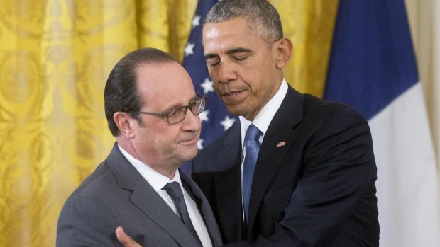 US President Barack Obama, right, greets French President Francois Hollande.