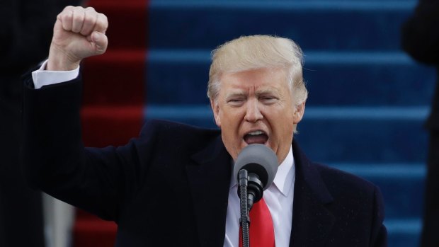 President Donald Trump pumps his fist after delivering his inaugural address.