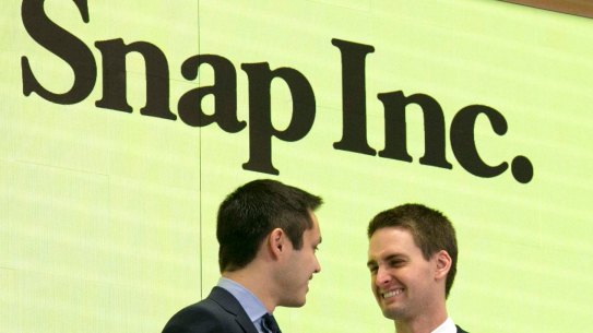 Snapchat co-founders Bobby Murphy, left, and CEO Evan Spiegel, center, ring the opening bell at the New York Stock Exchange on March 2.