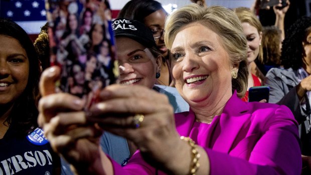 Democratic presidential candidate Hillary Clinton takes selfie with a supporter at a rally in Raleigh.
