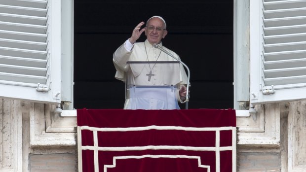 Pope Francis from his studio's window overlooking St Peter's Square, at the Vatican, on Sunday.