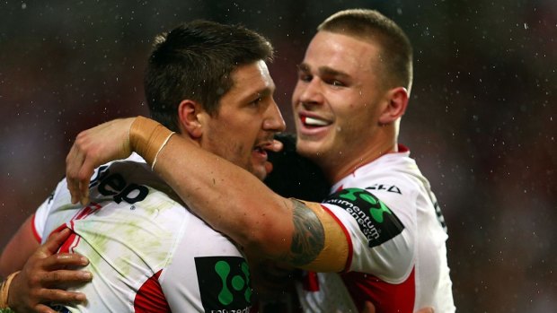 Eye of the storm: Euan Aitken (right), who was accused of diving by Roosters coach Trent Robinson, celebrates with Gareth Widdop on Anzac Day.